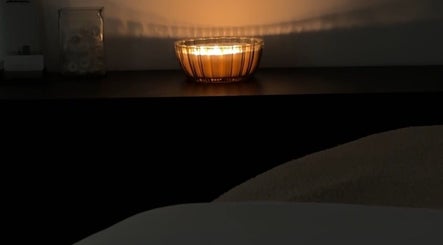 Warm candlelight ambiance at Esthetics by Tay, Newport Beach, California, US creates a relaxing spa atmosphere.