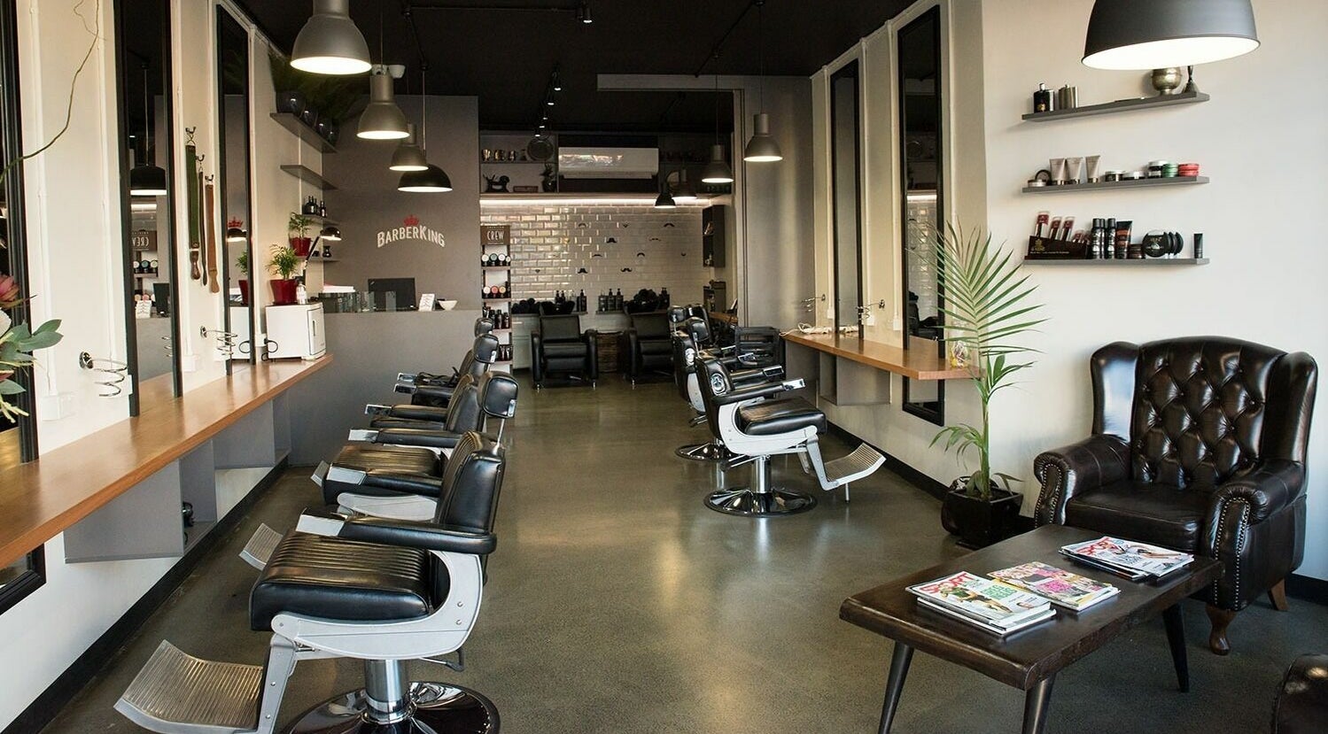 Modern interior of Barber King, Sandy Bay, Tasmania, AU, showcasing sleek barber chairs and stylish decor.