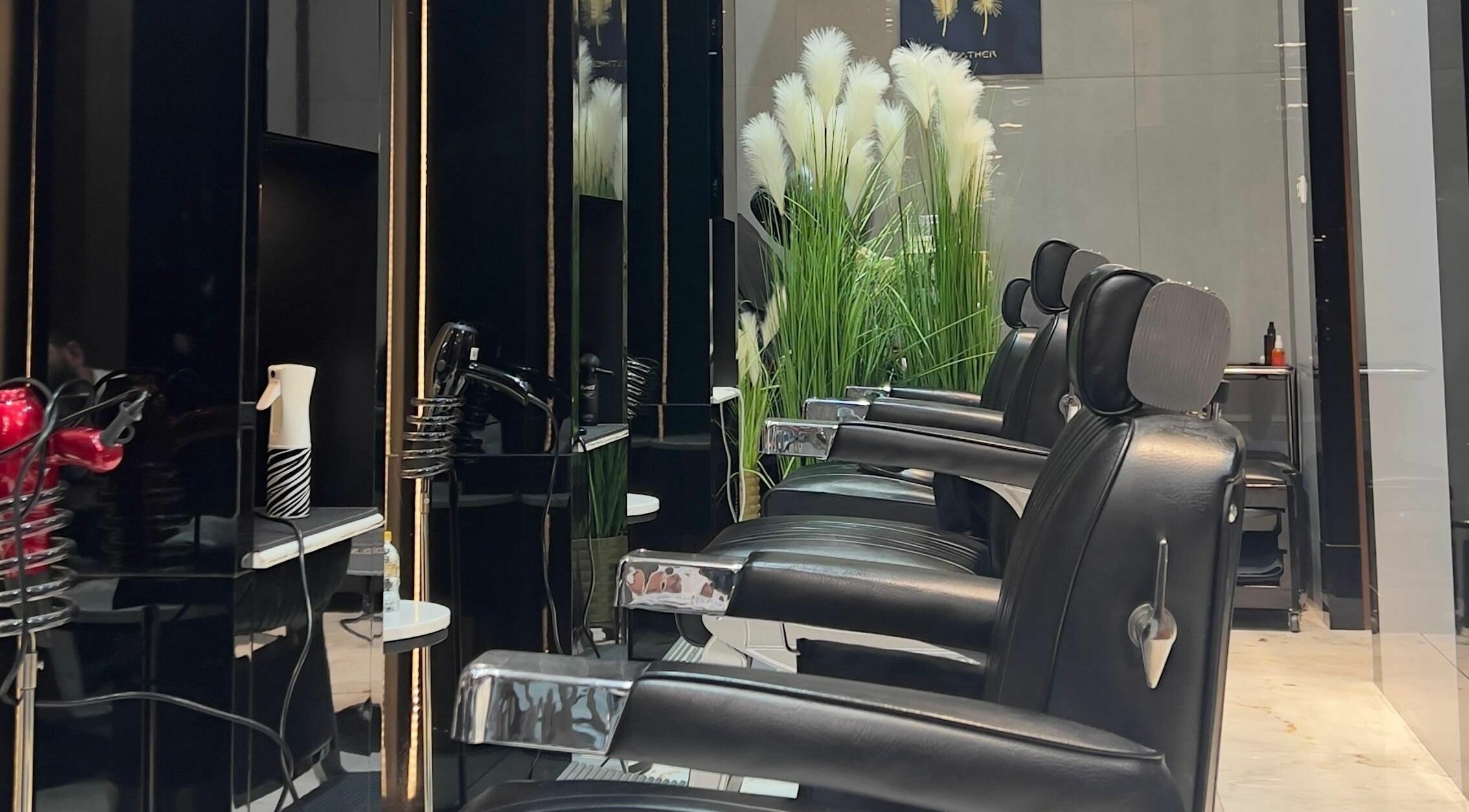Stylish barber chairs at Aspire Barber House Gents Salon - Atana Hotel, Dubai, AE, exuding modern elegance.