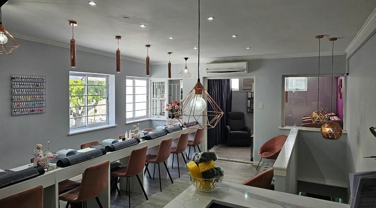 Modern and chic interior of Mc Nail and Beauty Salon in Cape Town, Western Cape, ZA with stylish lighting and seating.