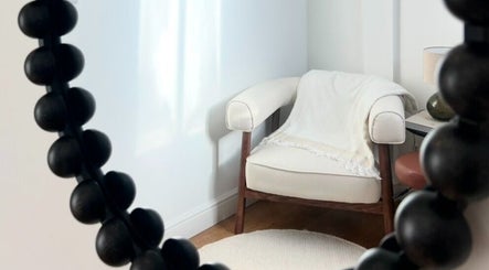 Elegant relaxation corner at Niamh Trevor Skin, Hampstead Norreys, England, GB, featuring a plush armchair.