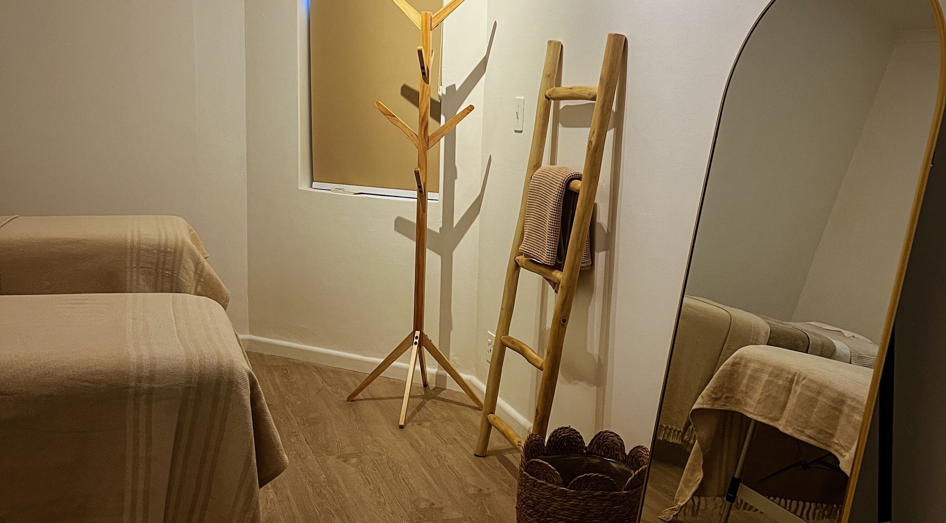 Tranquil therapy room with natural wood decor at Kobido Cape Town, Cape Town, Western Cape, ZA.