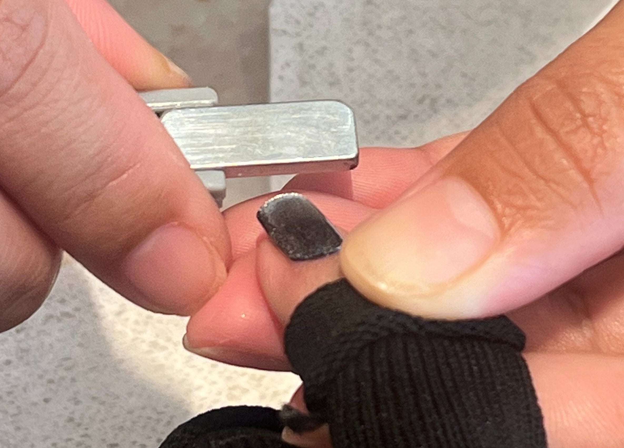 Manicure service at Nai Spa, Riyadh. Close-up of nail trimming precision.