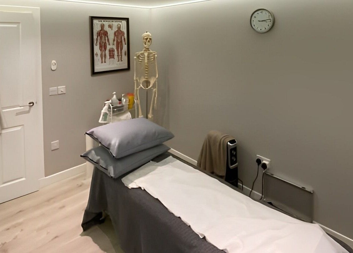 Therapy room at Complementary Health, Balmedie, Scotland, GB with treatment table and anatomical decor.