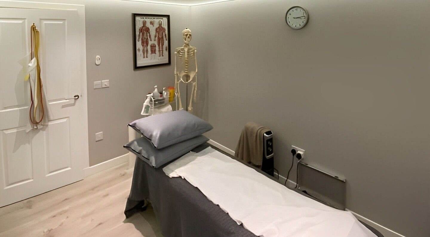 Therapy room at Complementary Health, Balmedie, Scotland, GB with treatment table and anatomical decor.