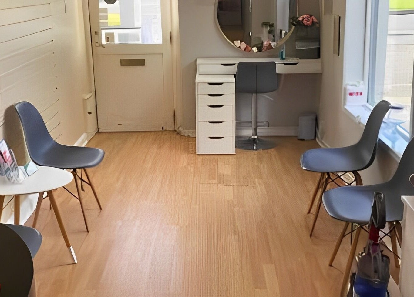 Bright interior of Complementary Health in Balmedie, Scotland, GB, featuring modern chairs and a beauty station.