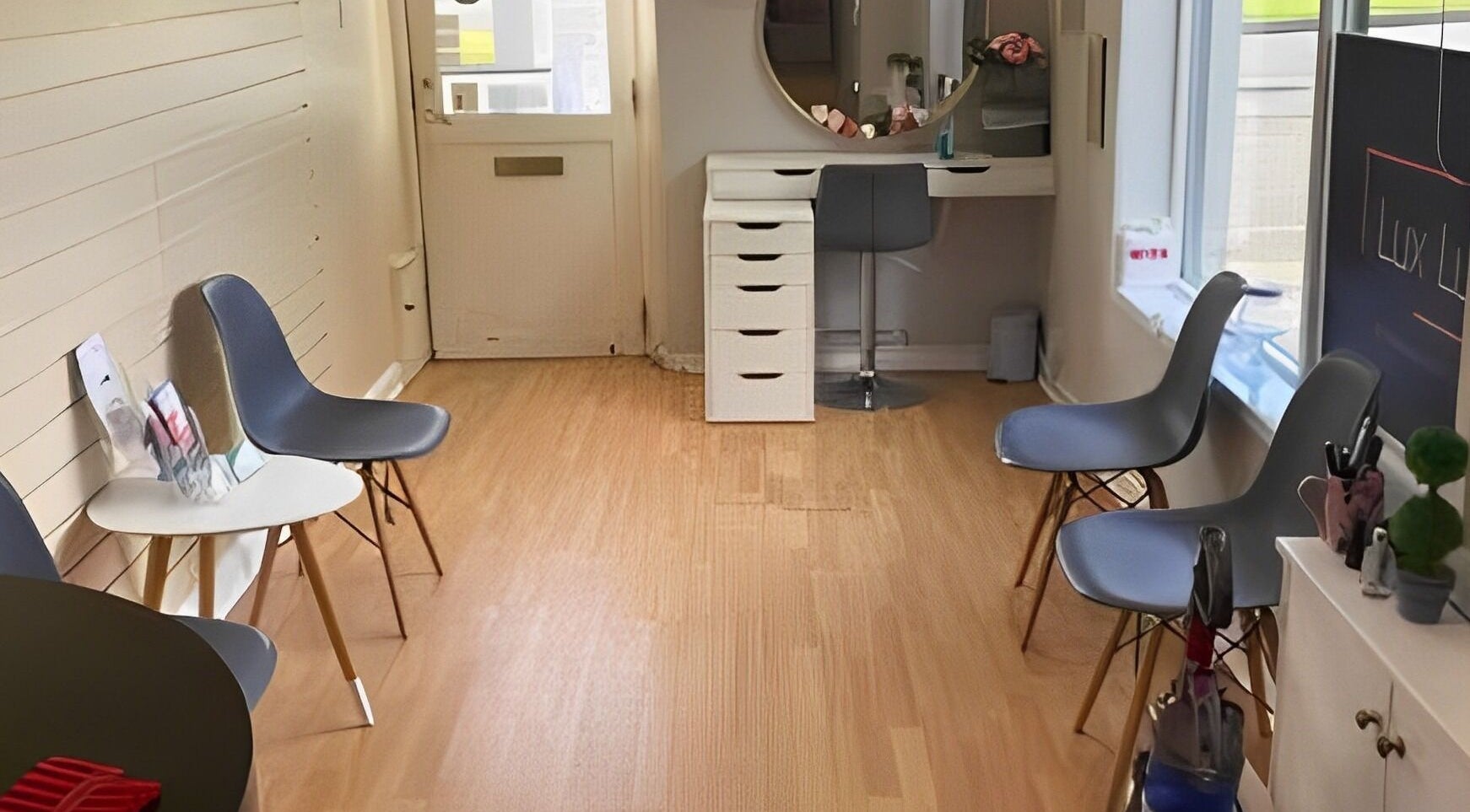 Bright interior of Complementary Health in Balmedie, Scotland, GB, featuring modern chairs and a beauty station.