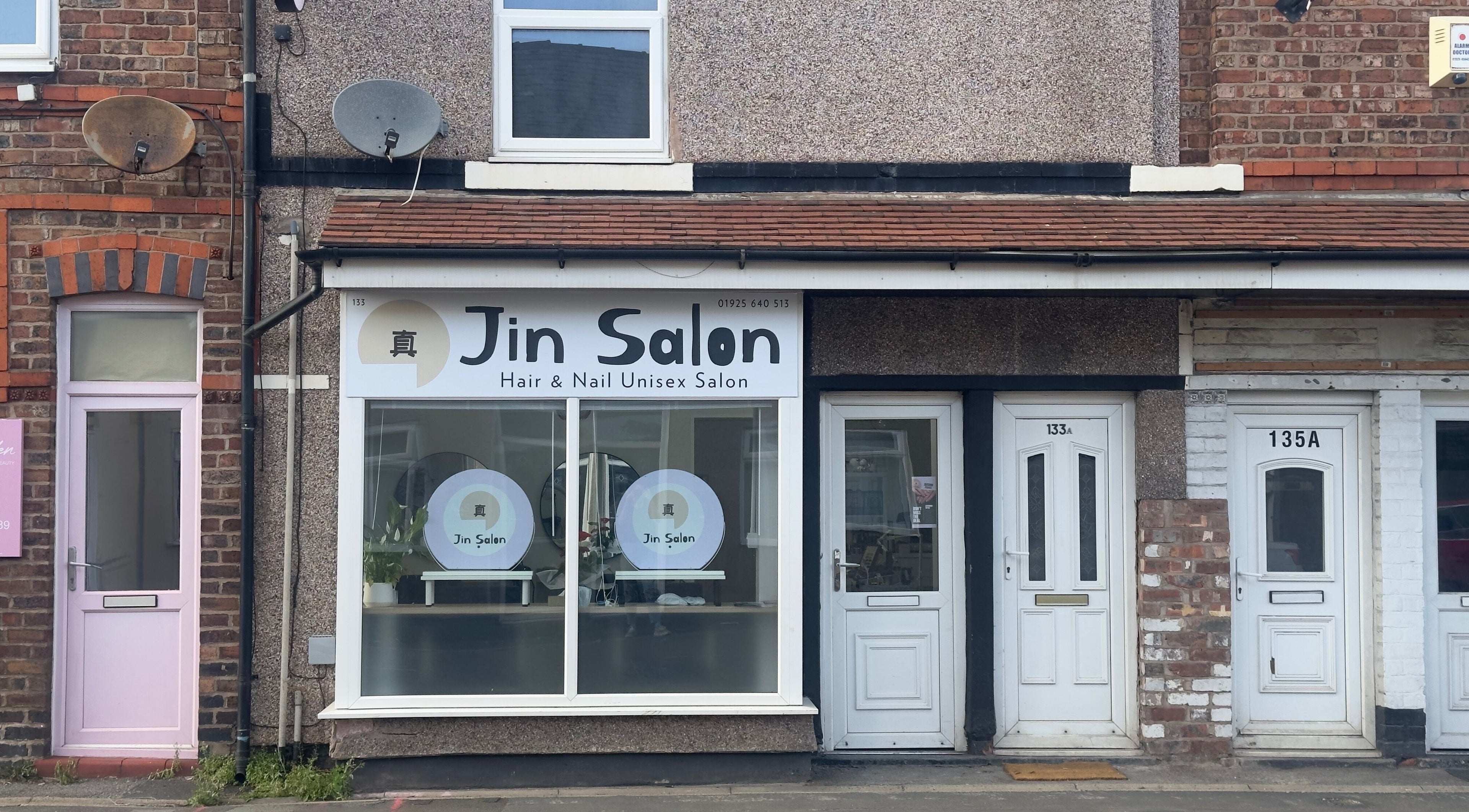 Exterior view of 真Jin Salon in Warrington, England, GB, showcasing the salon's stylish entrance.