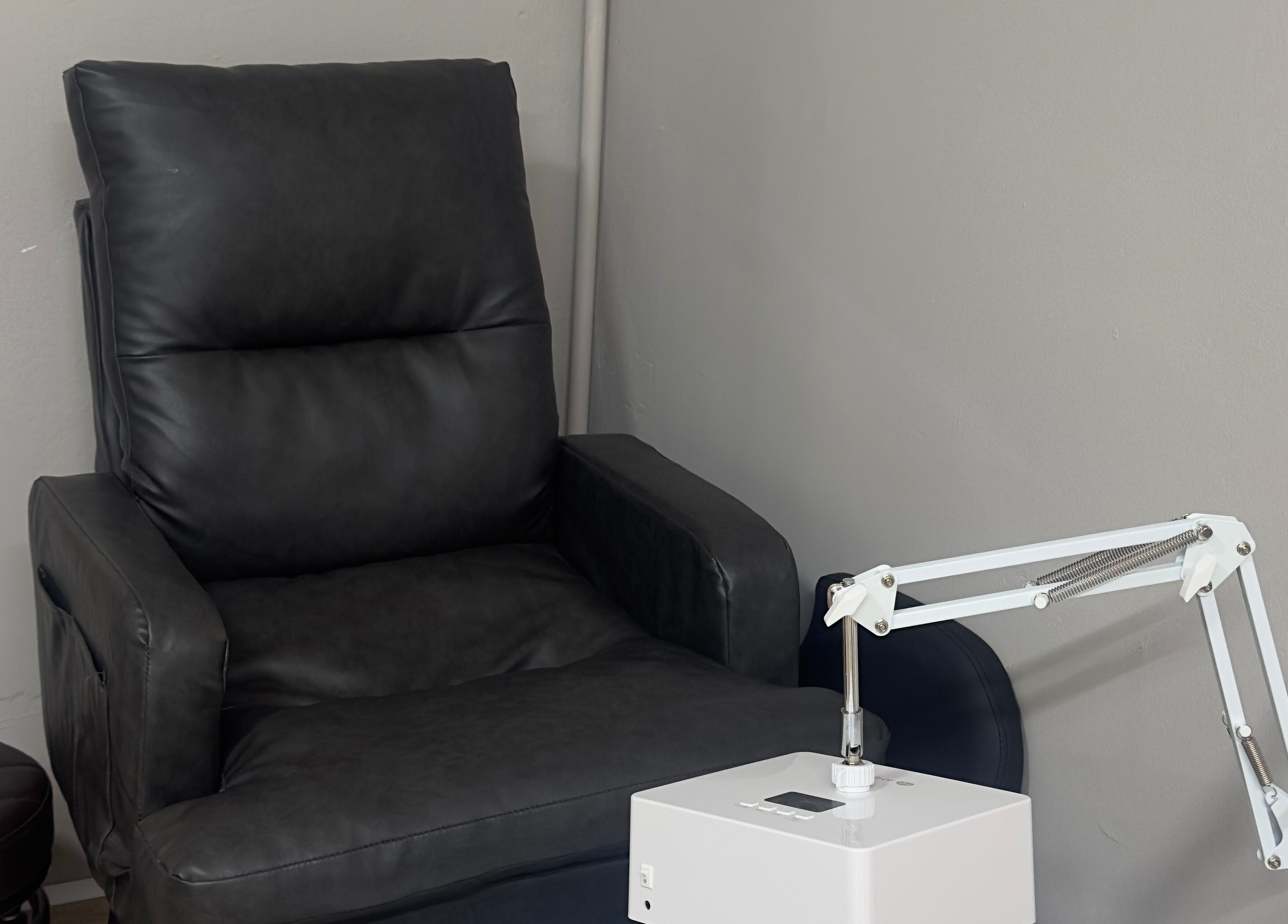 Comfortable massage chair at 真Jin Salon in Warrington, England, GB, with modern spa equipment.