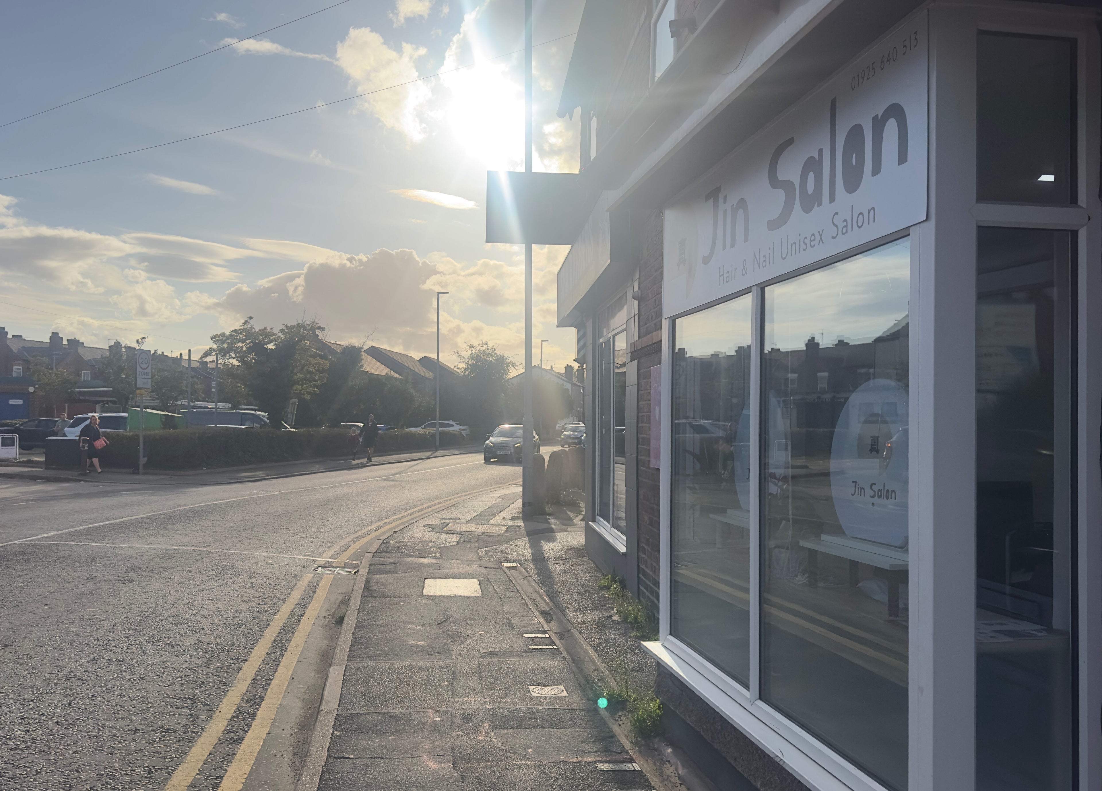 Exterior view of 真Jin Salon under bright sun in Warrington, England, GB, showcasing the modern storefront.