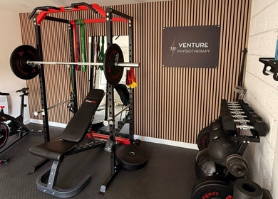 Modern gym setup at Venture Physiotherapy in Leicester, England, GB with bikes and weights.