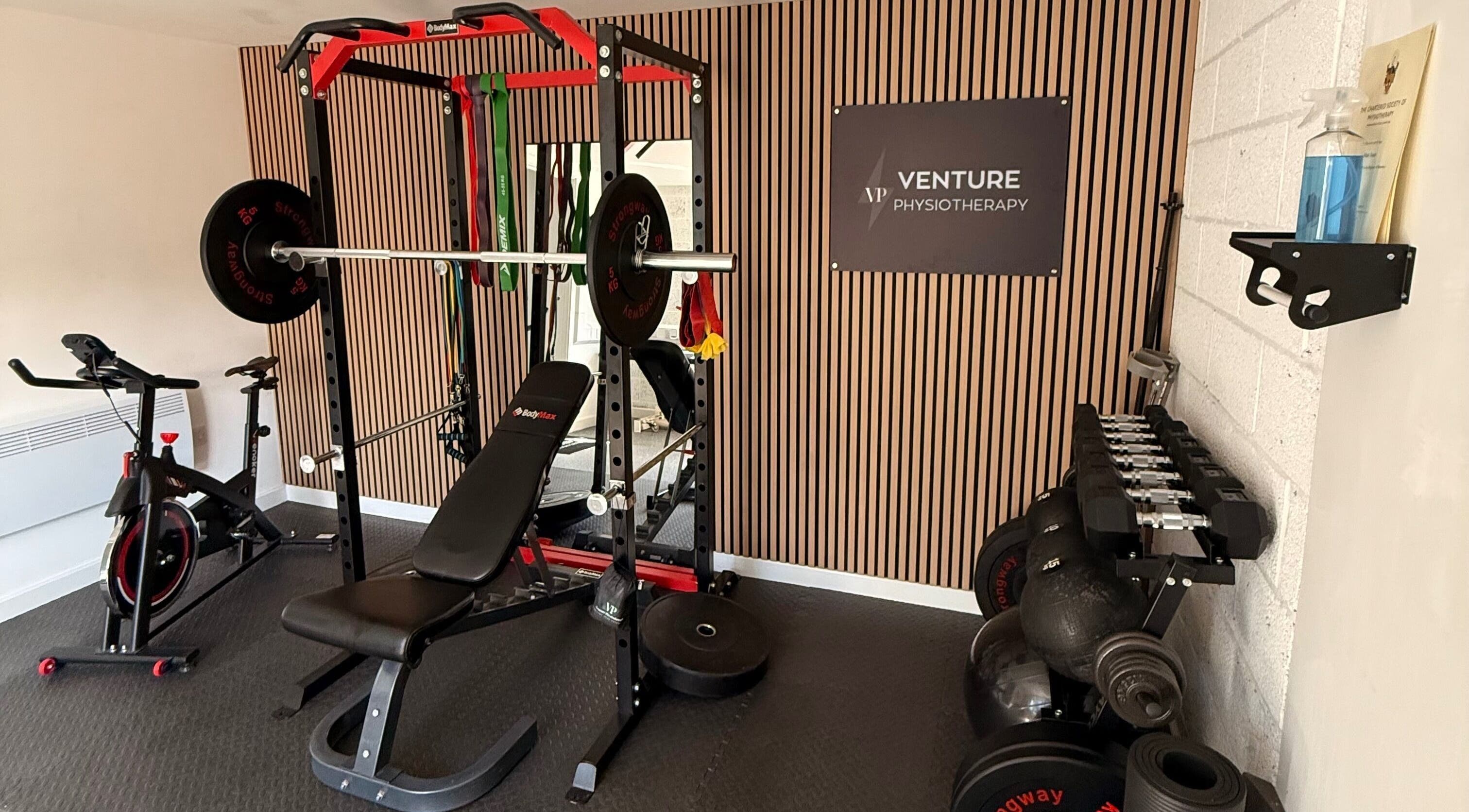 Modern gym setup at Venture Physiotherapy in Leicester, England, GB with bikes and weights.