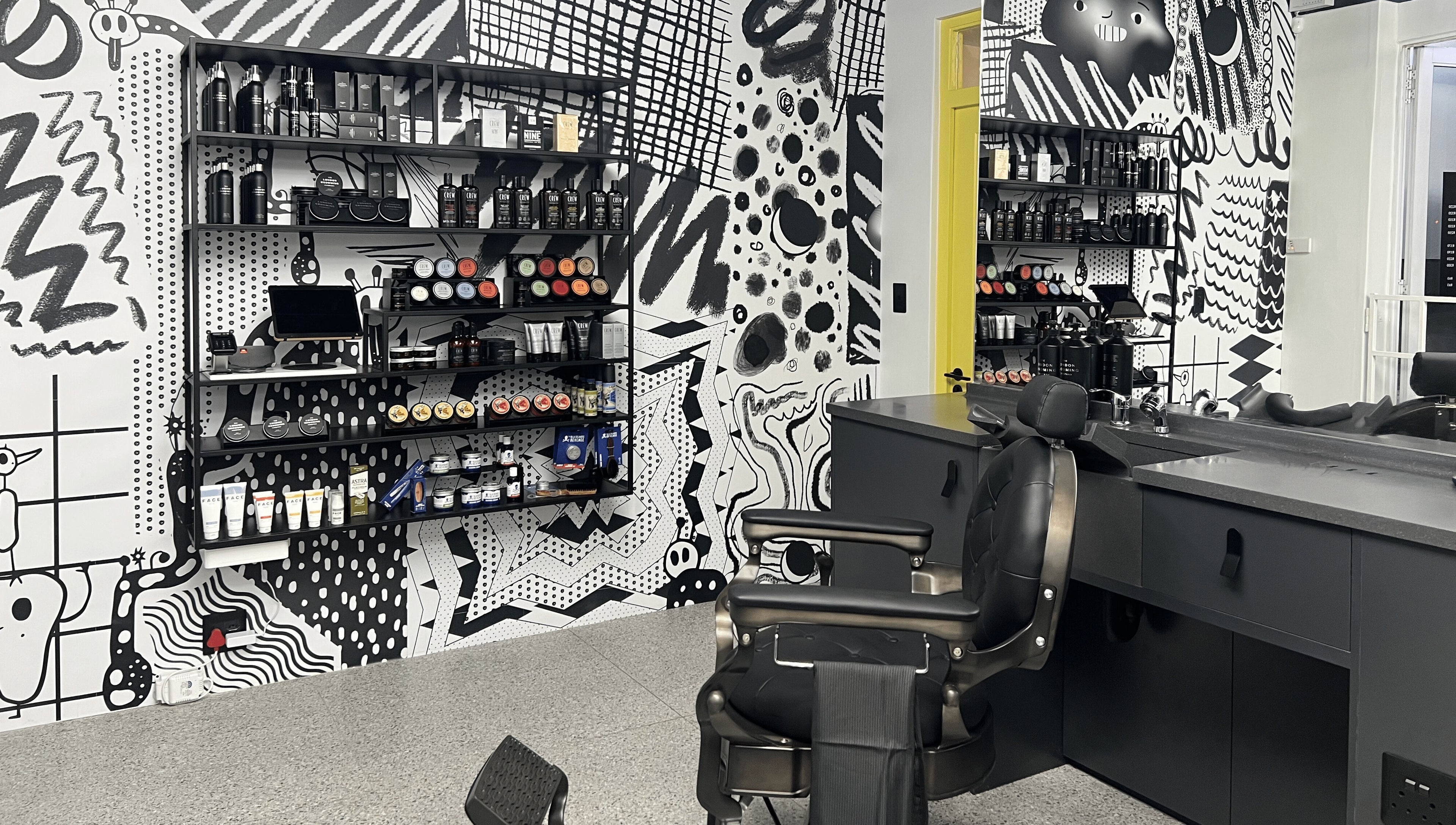 Stylish interior of Barnet Fair Sea Point in Cape Town, Western Cape, ZA featuring modern barber chairs and products.