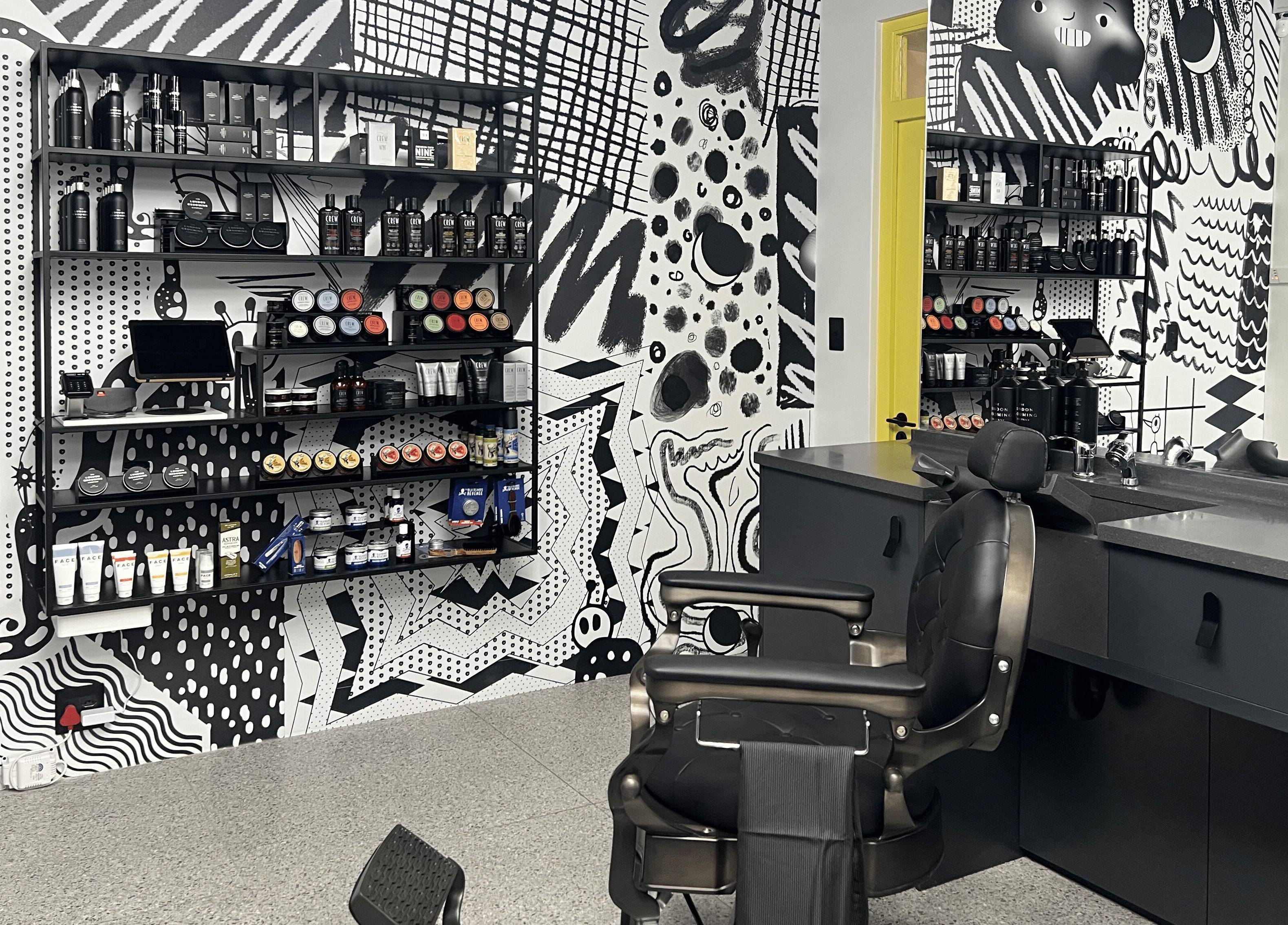 Stylish interior of Barnet Fair Sea Point in Cape Town, Western Cape, ZA featuring modern barber chairs and products.