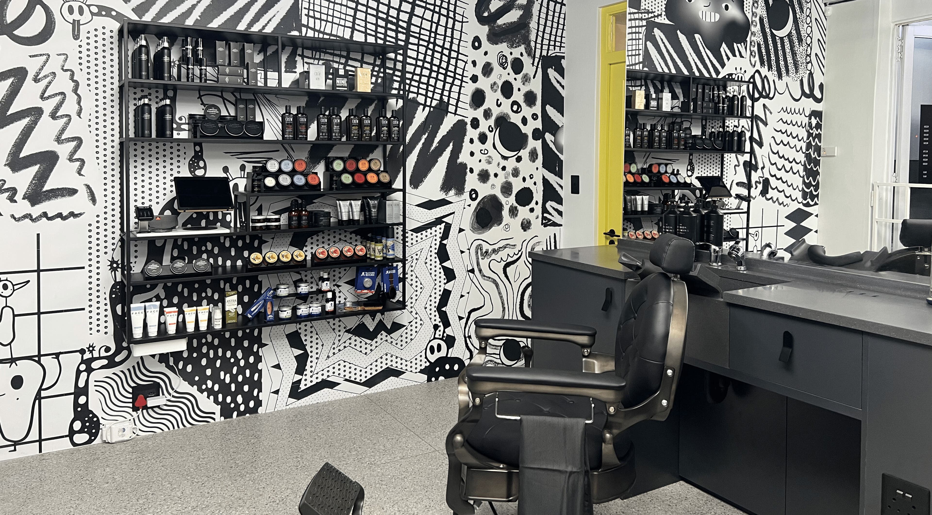 Stylish interior of Barnet Fair Sea Point in Cape Town, Western Cape, ZA featuring modern barber chairs and products.