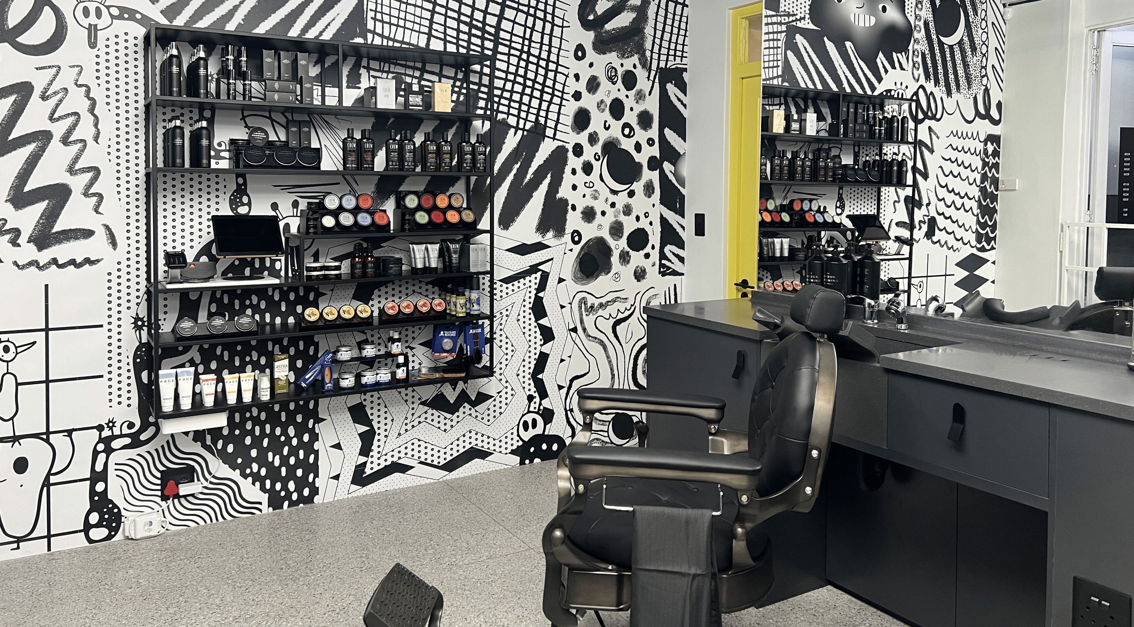 Stylish interior of Barnet Fair Sea Point in Cape Town, Western Cape, ZA featuring modern barber chairs and products.