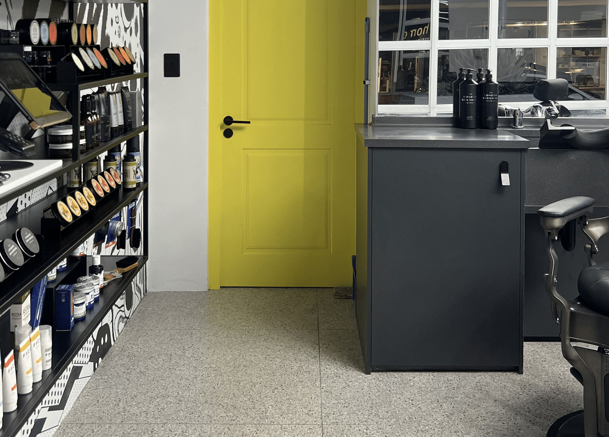 Modern barbershop interior at Barnet Fair Sea Point, Cape Town, Western Cape, ZA, with bold decor and grooming products.