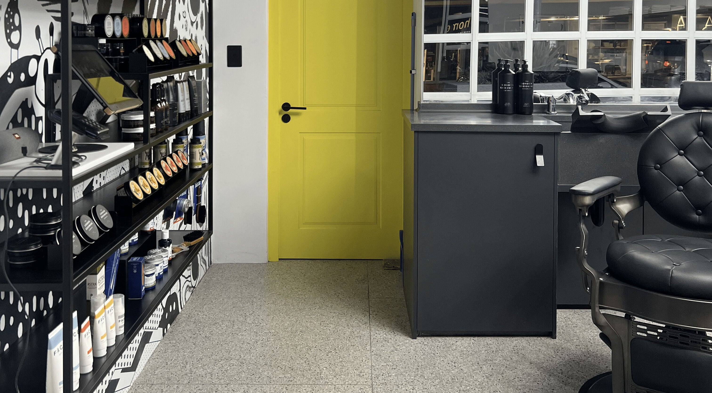 Modern barbershop interior at Barnet Fair Sea Point, Cape Town, Western Cape, ZA, with bold decor and grooming products.