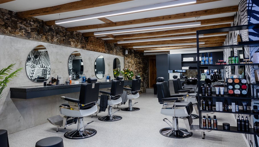 Modern salon at Barnet Fair Bree Street, Cape Town, Western Cape, ZA with sleek chairs and decor.