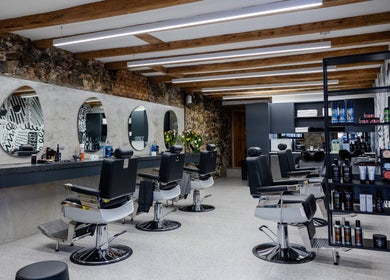 Modern salon at Barnet Fair Bree Street, Cape Town, Western Cape, ZA with sleek chairs and decor.