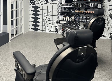 Modern barber chairs and artistic wall at Barnet Fair Bree Street, Cape Town, Western Cape, ZA.