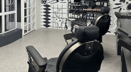 Modern barber chairs and artistic wall at Barnet Fair Bree Street, Cape Town, Western Cape, ZA.