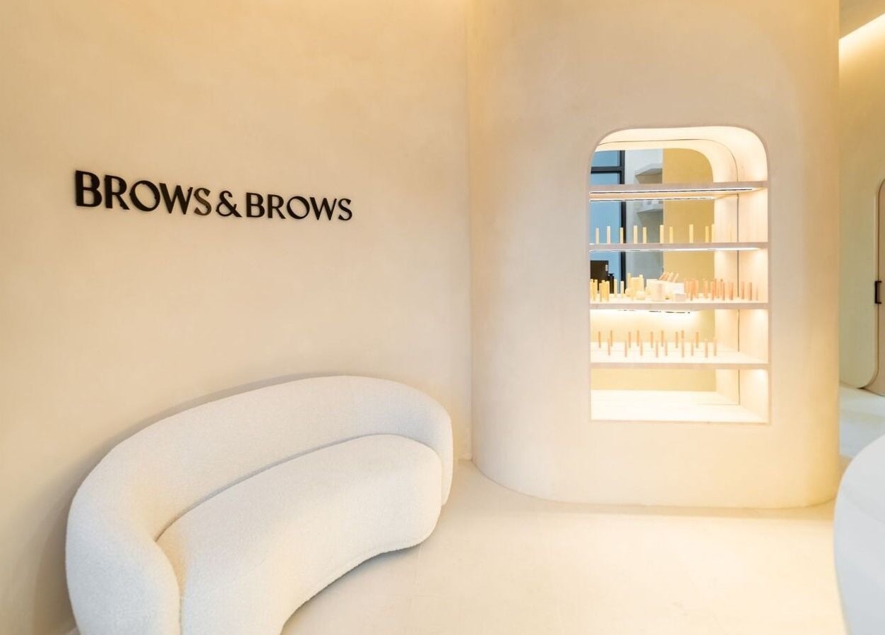Chic interior at Brows and Brows in Hallandale Beach, Florida, US with elegant sofa and product display.