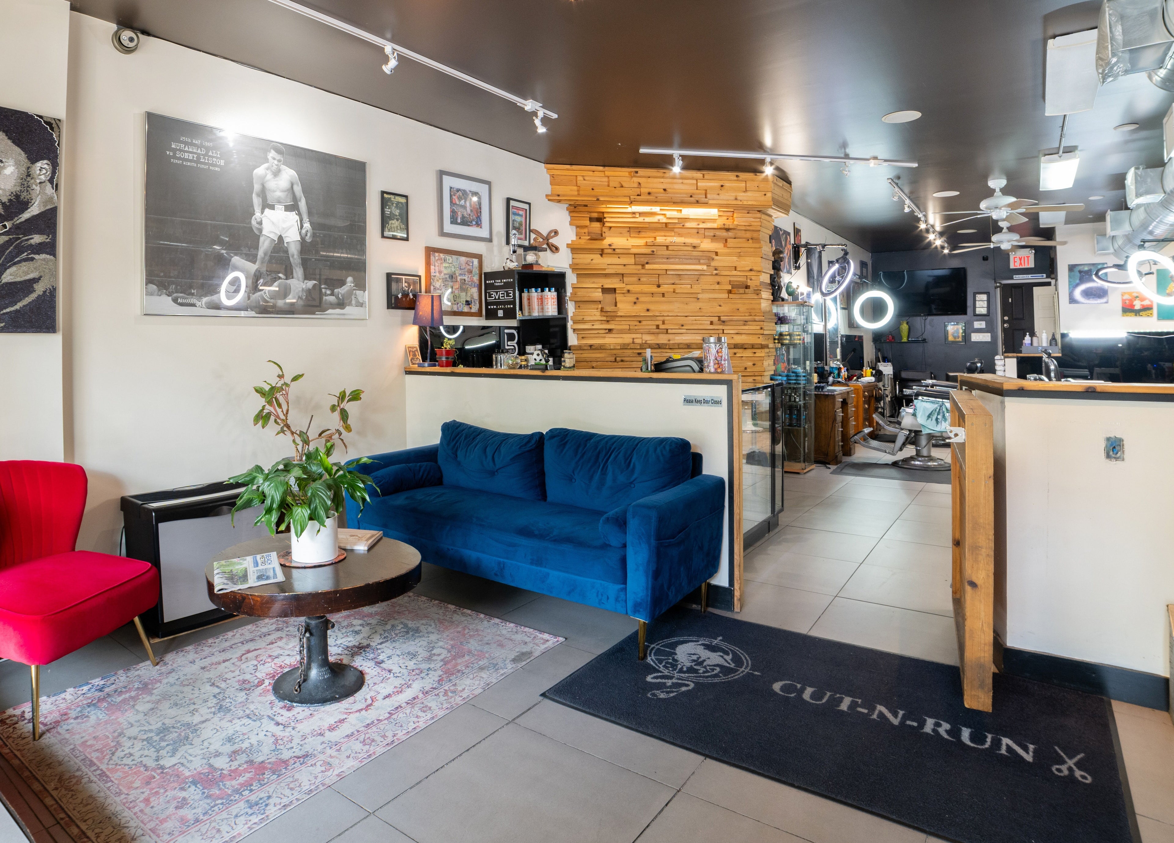 Stylish interior of Cut N Run Barbershop, Toronto, Ontario, CA, showcasing modern seating and decor.
