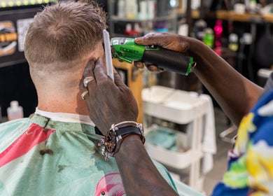 Expert barber giving a stylish haircut at Cut N Run Barbershop, Toronto, Ontario, CA.