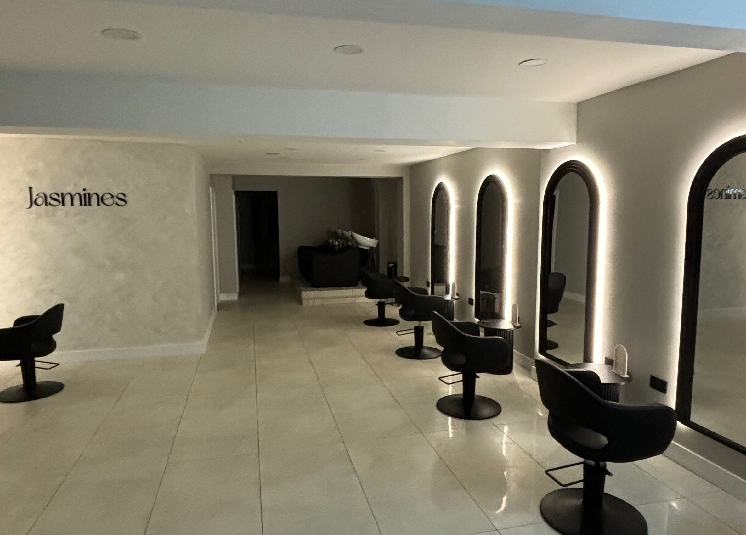Chic interior of Jasmines salon in Fareham, England, GB with sleek chairs and illuminated mirrors.