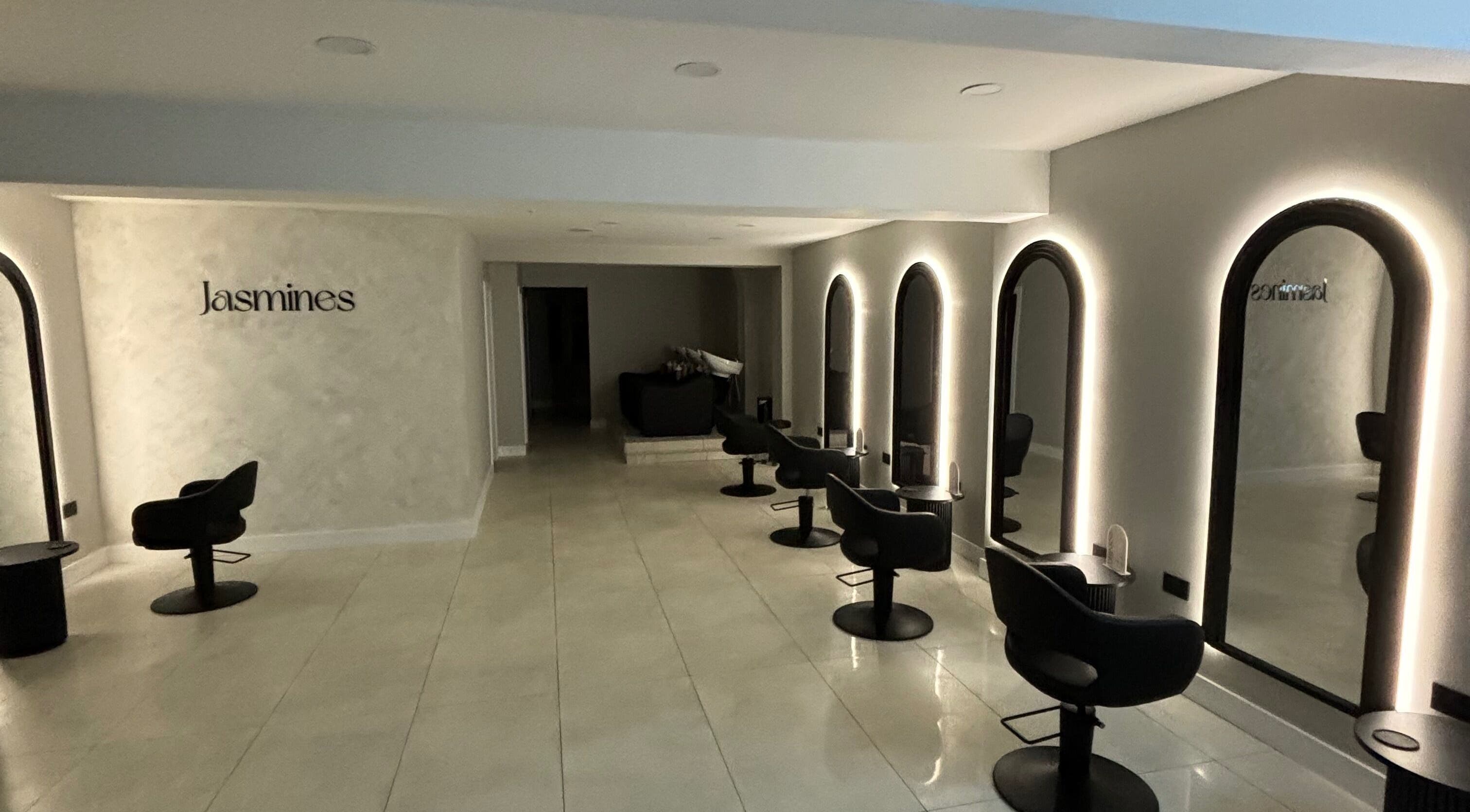 Chic interior of Jasmines salon in Fareham, England, GB with sleek chairs and illuminated mirrors.