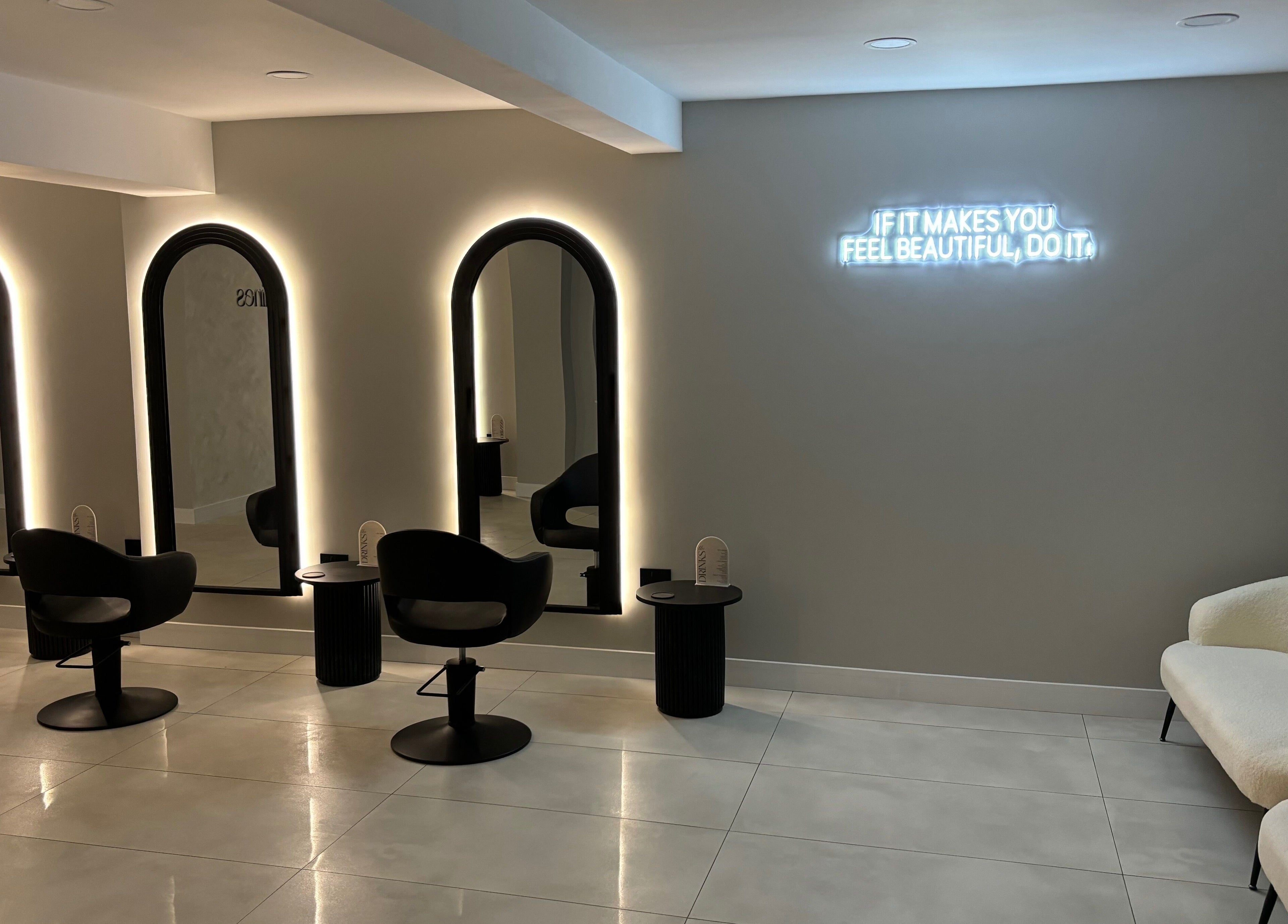 Interior of Jasmines in Fareham, England, GB, featuring illuminated mirrors and stylish seating.