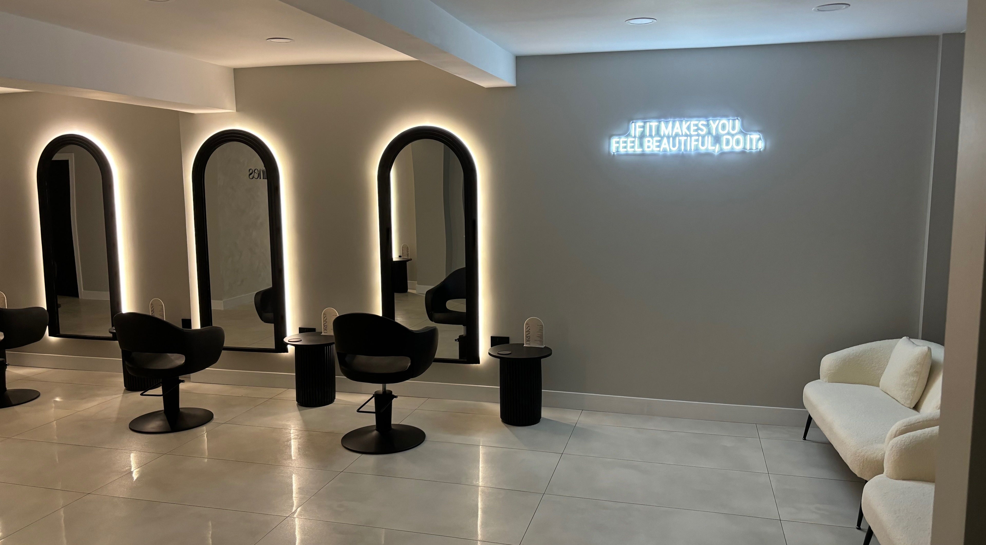 Interior of Jasmines in Fareham, England, GB, featuring illuminated mirrors and stylish seating.