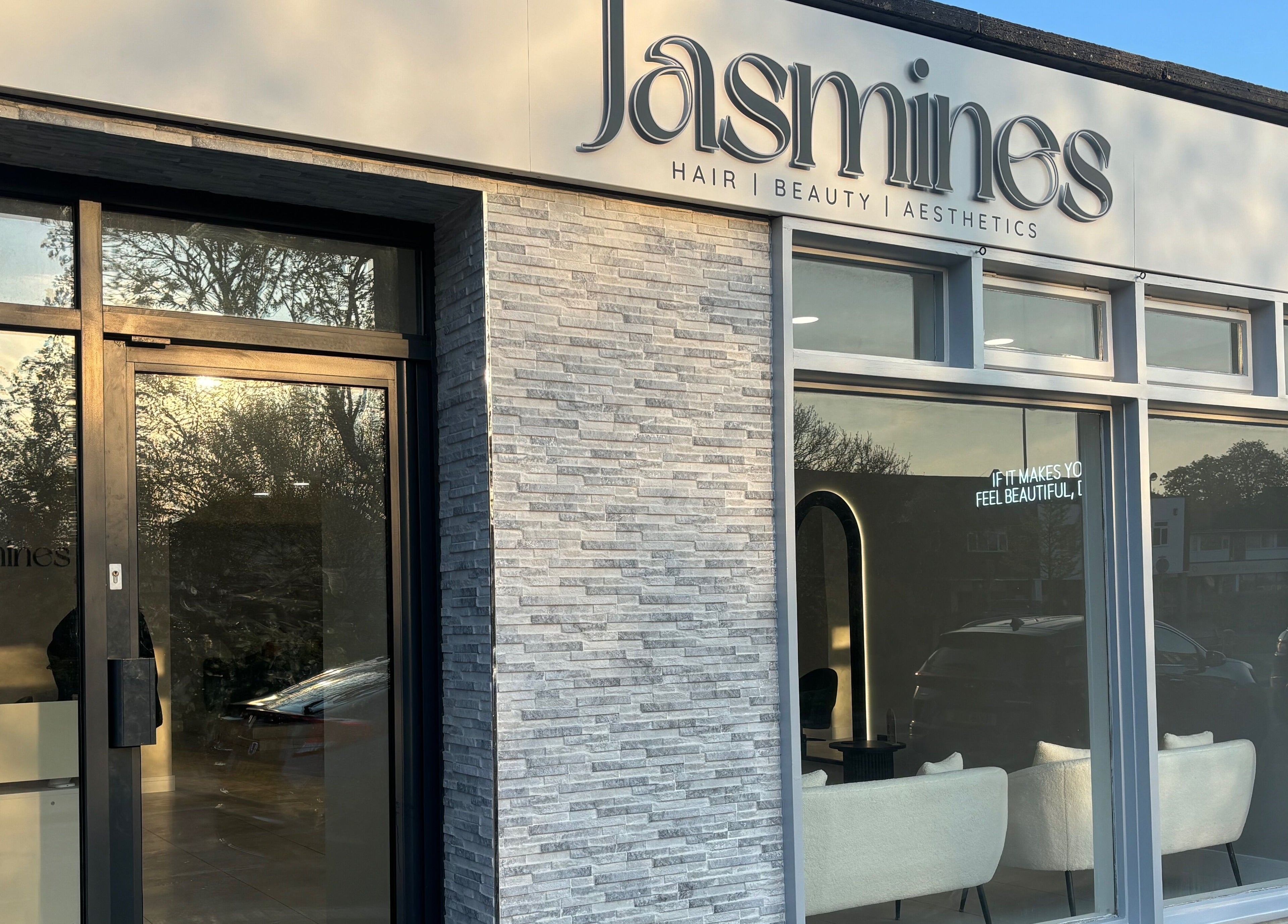 Front entrance of Jasmines beauty and wellness center in Fareham, England, GB with sleek modern design.