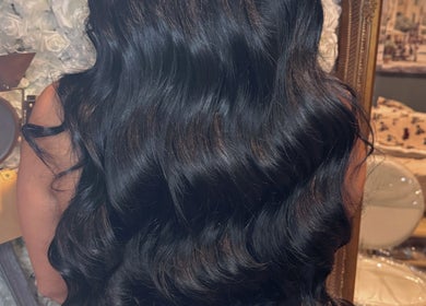 Long, black wavy hair styled at Hair Extensions by Kinga Liu, Leeds, England, GB, in an elegant salon setting.
