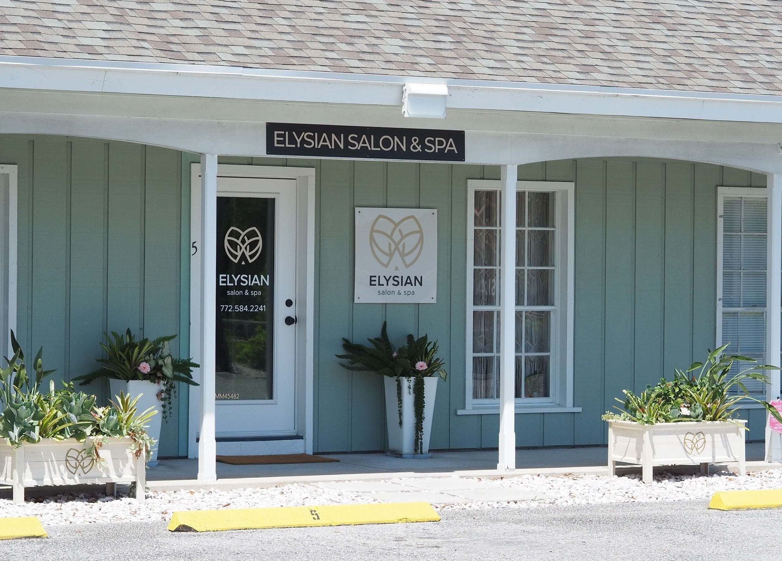 Front view of Elysian Salon and Spa, Vero Beach, Florida, showcasing elegant entrance and signage.