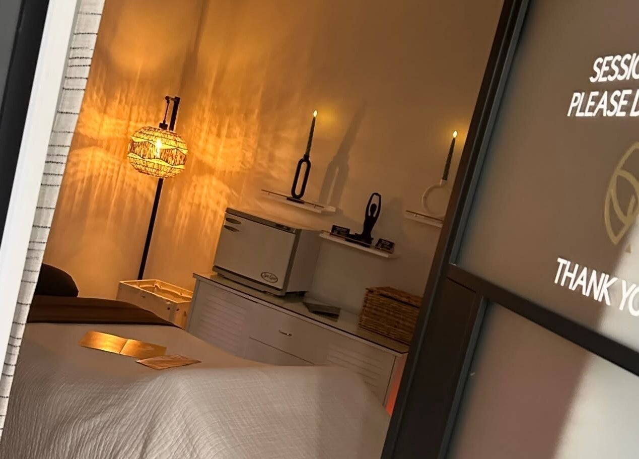 Cozy treatment room at Elysian Salon and Spa, Vero Beach, Florida, US, with soft lighting and relaxing decor.