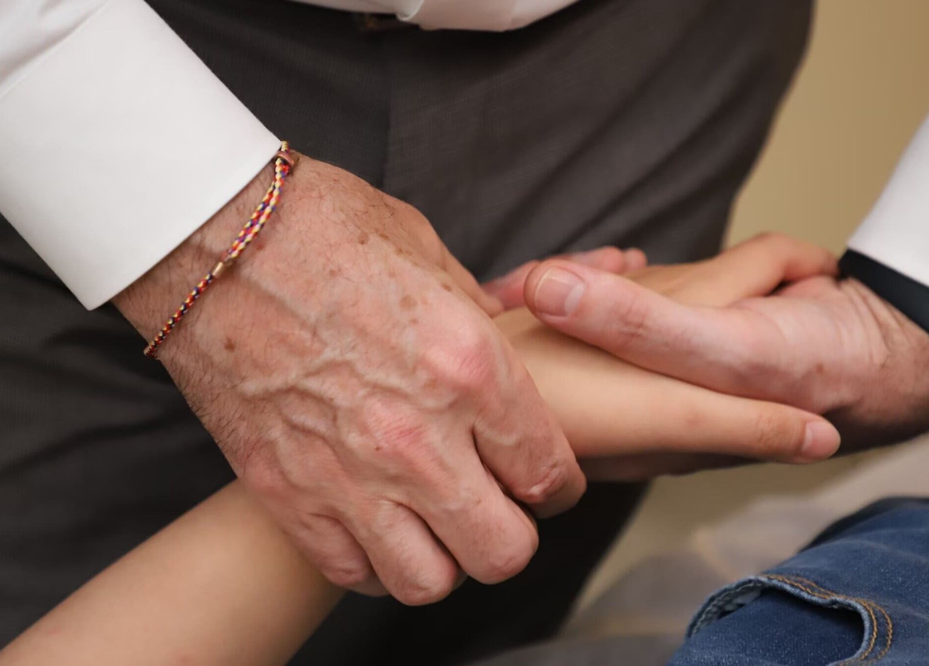Therapist massaging wrist at CALM Community Acupuncture London Multibed Clinic, London, England, GB.