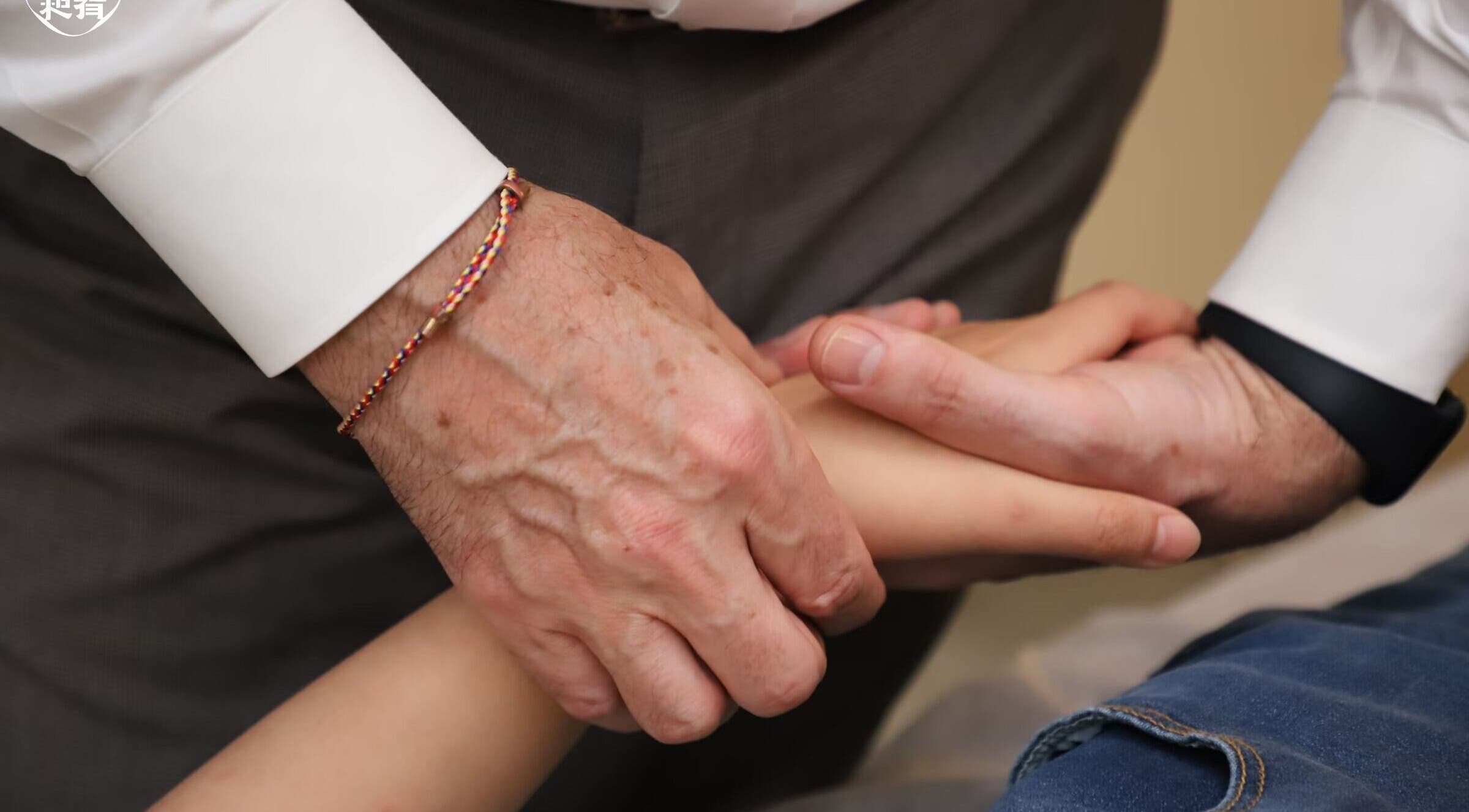 Therapist massaging wrist at CALM Community Acupuncture London Multibed Clinic, London, England, GB.