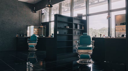 Sophisticated barber chairs at BarberBar at Pavilion Embassy, Kuala Lumpur, offering upscale grooming in a modern setting.