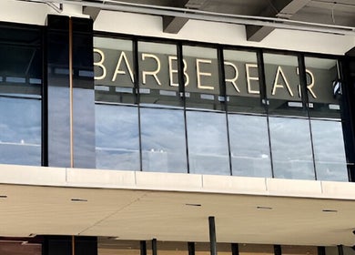 Entrance of BarberBar at Pavilion Embassy, Kuala Lumpur, featuring modern glass facade.