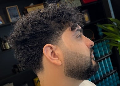 Man with stylish curly haircut at BarberBar, Pavilion Embassy, Kuala Lumpur, Wilayah Persekutuan Kuala Lumpur, MY.