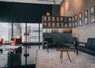 Stylish interior of BarberBar at Pavilion Embassy in Kuala Lumpur, showcasing vintage decor and modern seating.