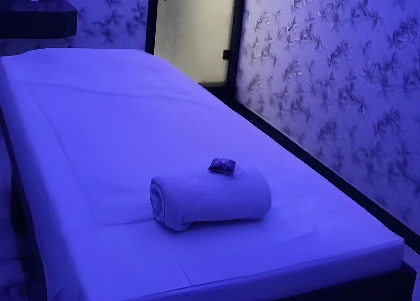 Tranquil massage room at Medusa Luxury Spa, Raipur, Chhattisgarh, IN with soft lighting and elegant decor.