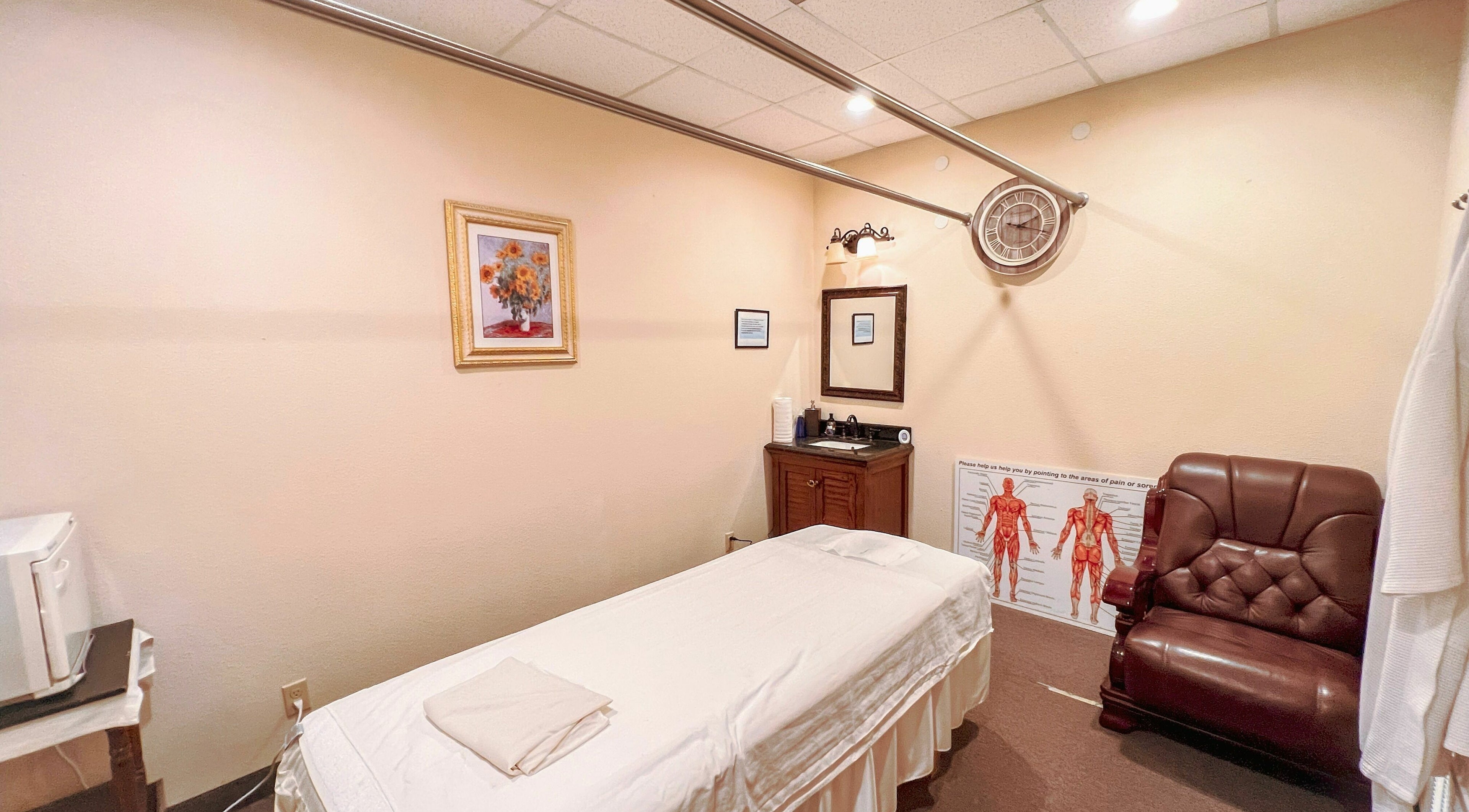 Tranquil massage room at Bluebonnet Massage, featuring a comfy chair and massage bed in Irving, Texas, US.