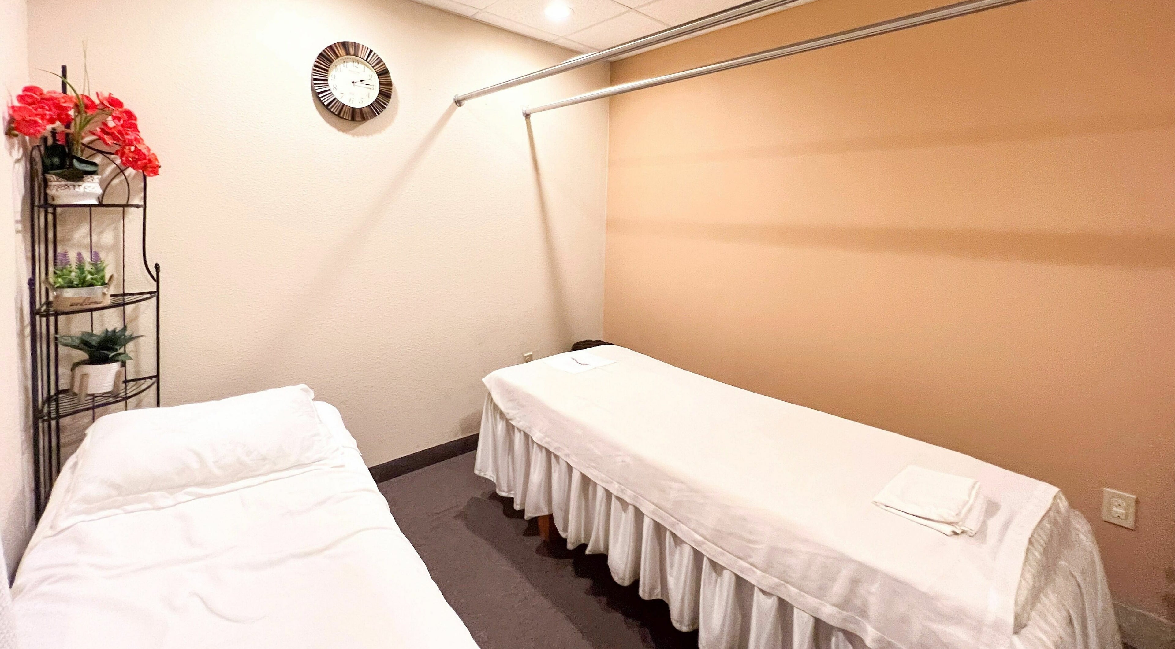 Peaceful massage room at Bluebonnet Massage in Irving, Texas, US, featuring two inviting massage tables.
