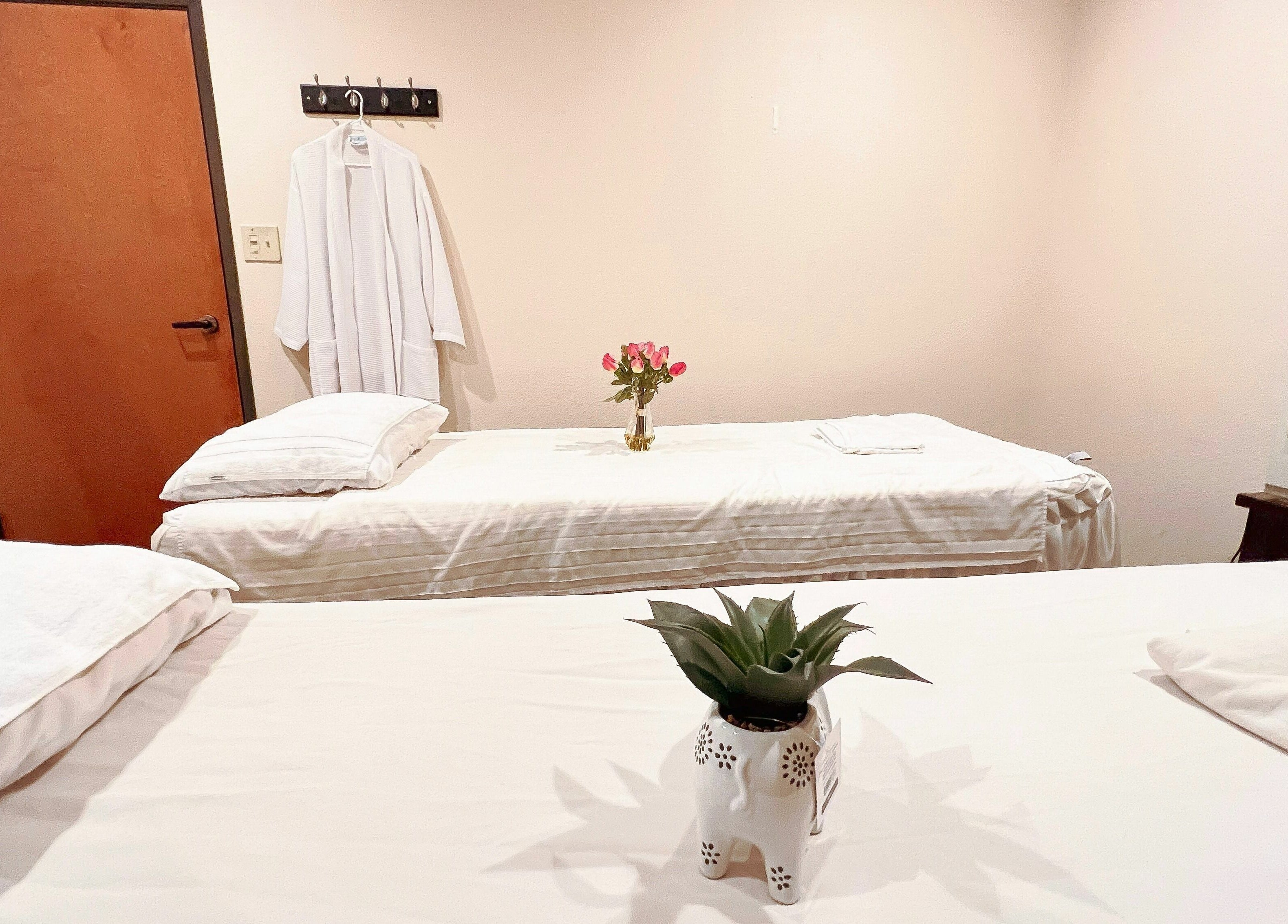 Peaceful massage room at Bluebonnet Massage, Irving, Texas, US with twin beds and soft lighting.