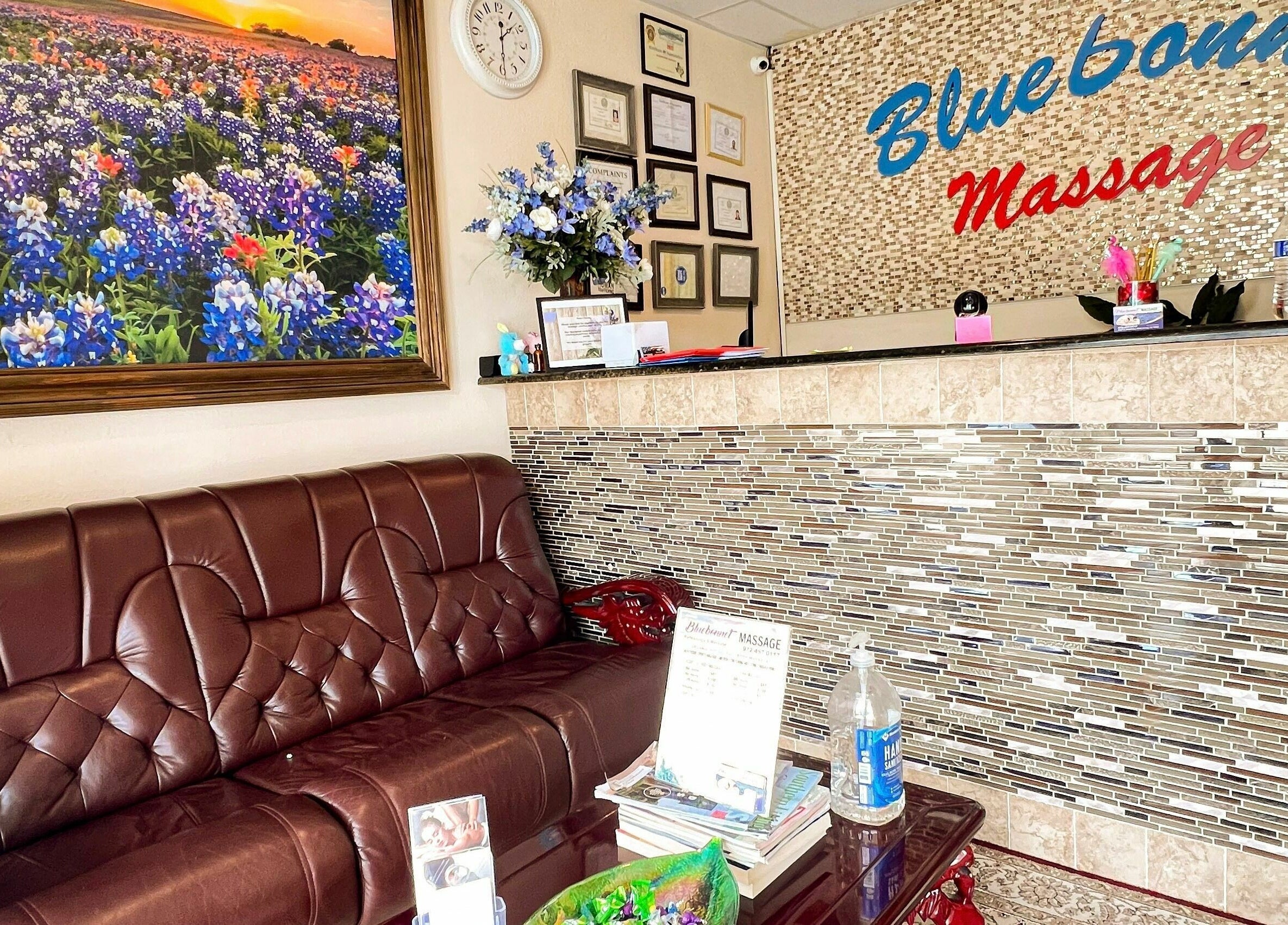 Cozy reception at Bluebonnet Massage, featuring a brown leather sofa in Irving, Texas, US.