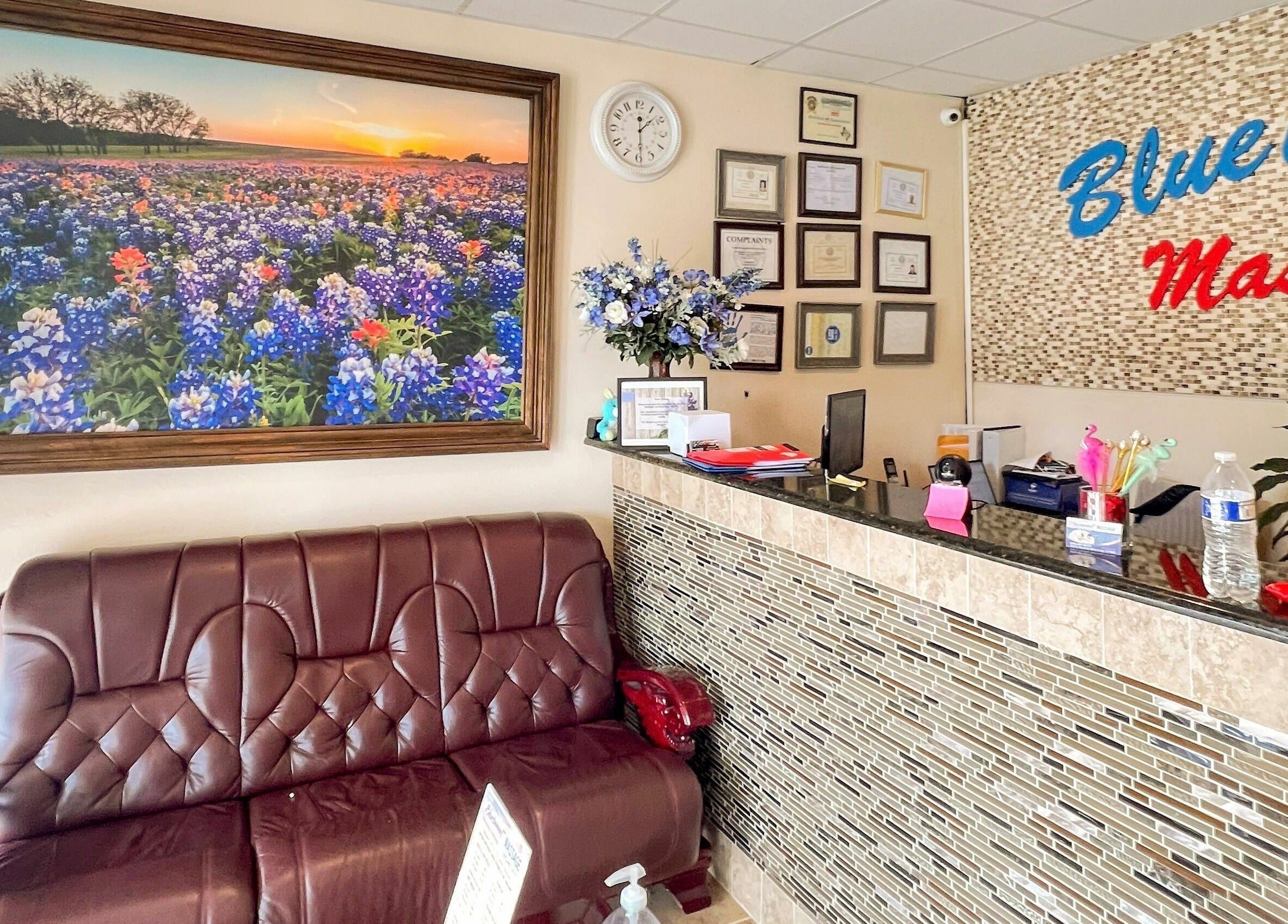 Bluebonnet Massage reception area with couch and floral decor, located in Irving, Texas, US.