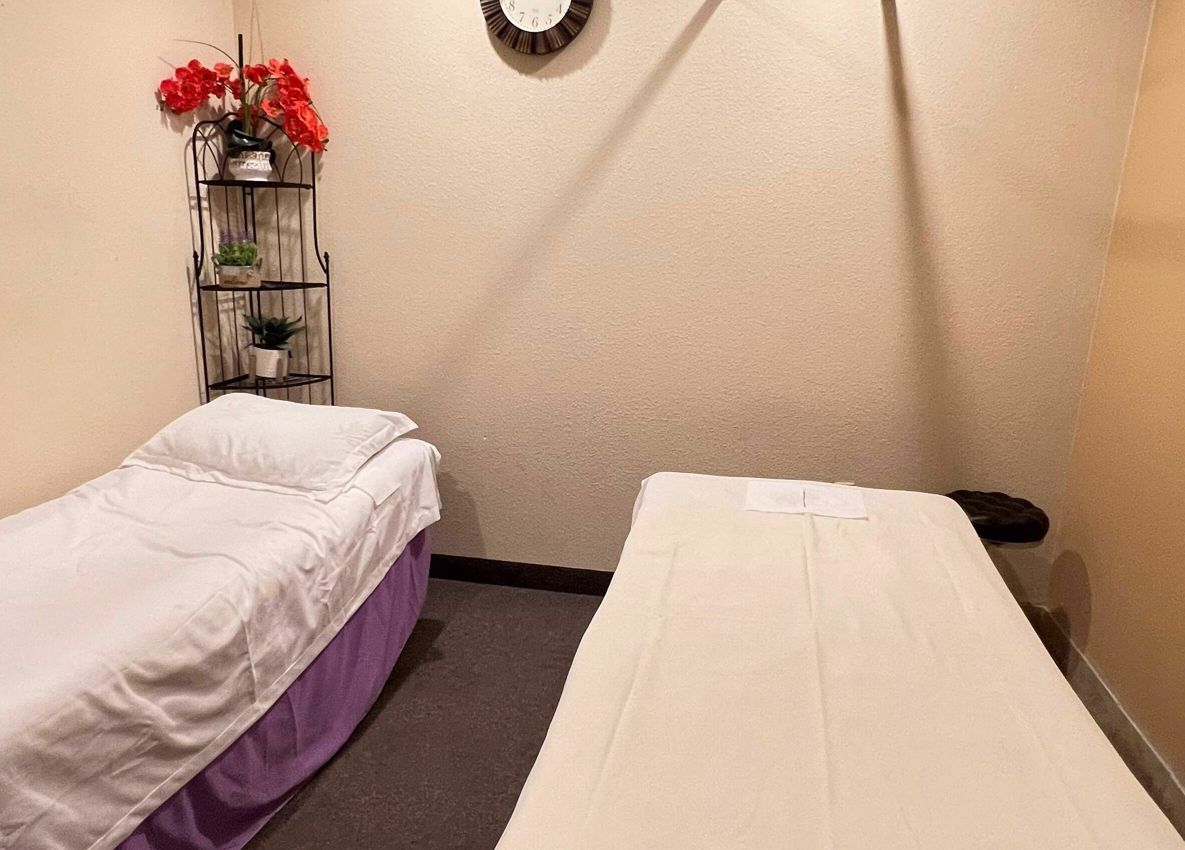 Peaceful massage room at Bluebonnet Massage, Irving, Texas, US with comfortable beds and calming decor.